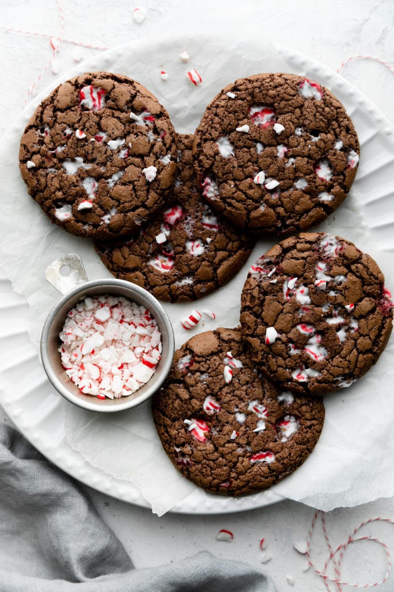 Several gluten-free peppermint brownie cookies on a white platter
