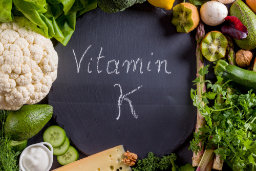 green vegetables around vitamin k text